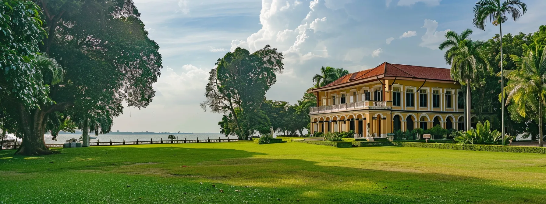 a historical colonial mansion surrounded by lush greenery, overlooking the serene sea in sembawang.